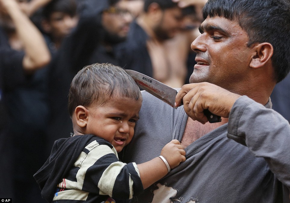 A man holds a knife to a baby