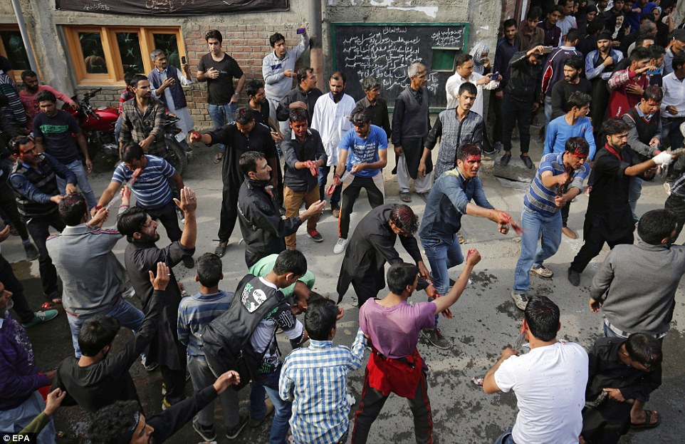 Kashmiri Shia Muslims flagellate themselves as they take part in a religious procession held on the seventh day of Islamic month of Muharram, in Srinagar