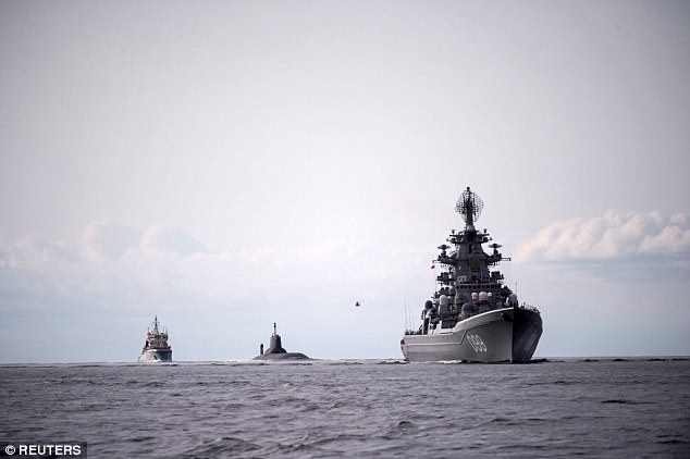 The submarine (centre) was pictured in Danish waters earlier this week as it made its way to the naval base for the parade