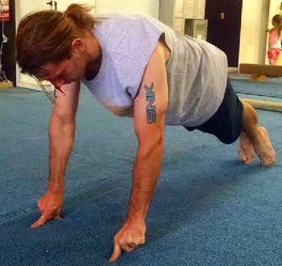 The author, Owen Johnston demonstrates a push-up on just the index fingers and thumbs.