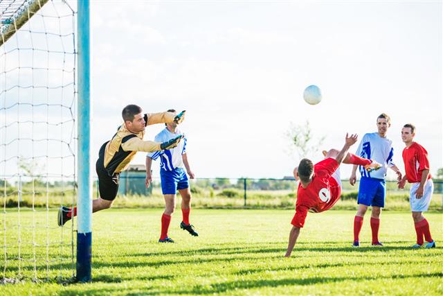 Group Of Soccer Players Playing Soccer