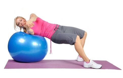 Fit young female pilates instructor showing different exercises